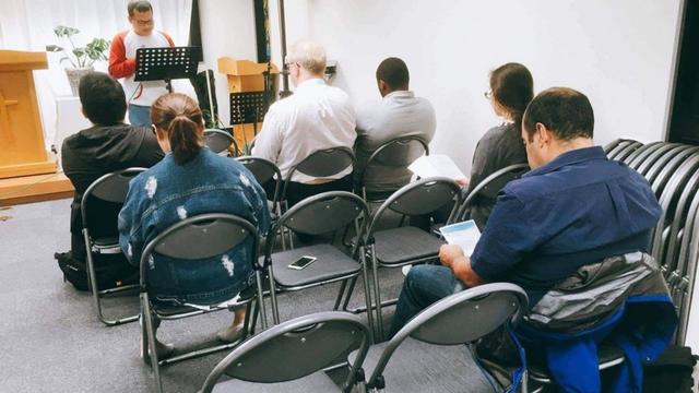 Mark Fino preaching at Living Stone Church, Tokyo. Tom Eskildsen is sitting in the first row.